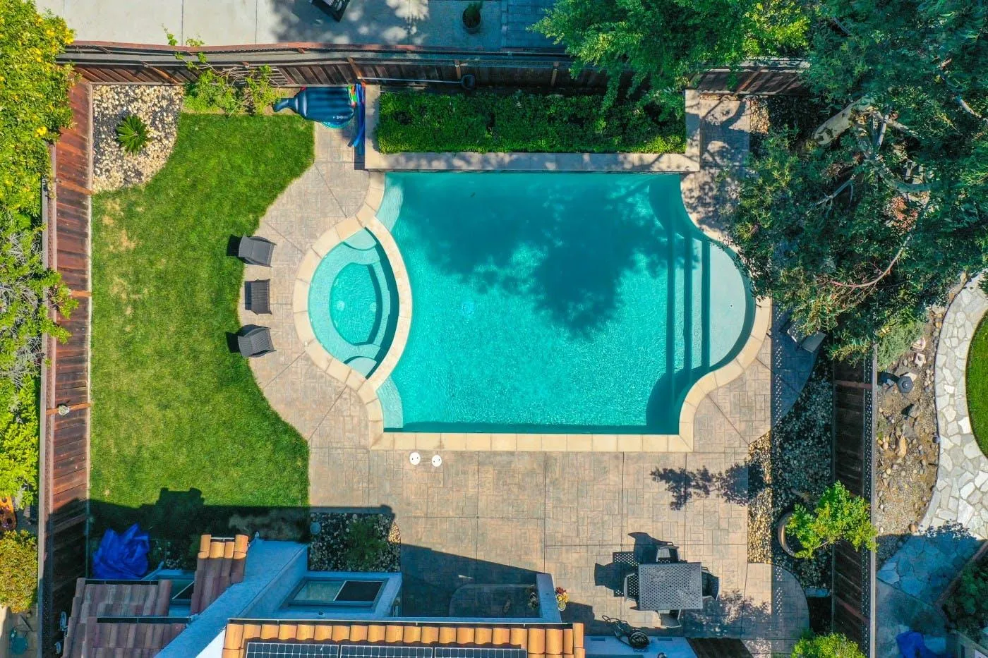 Backyard pool with a round attached spa, seen from above